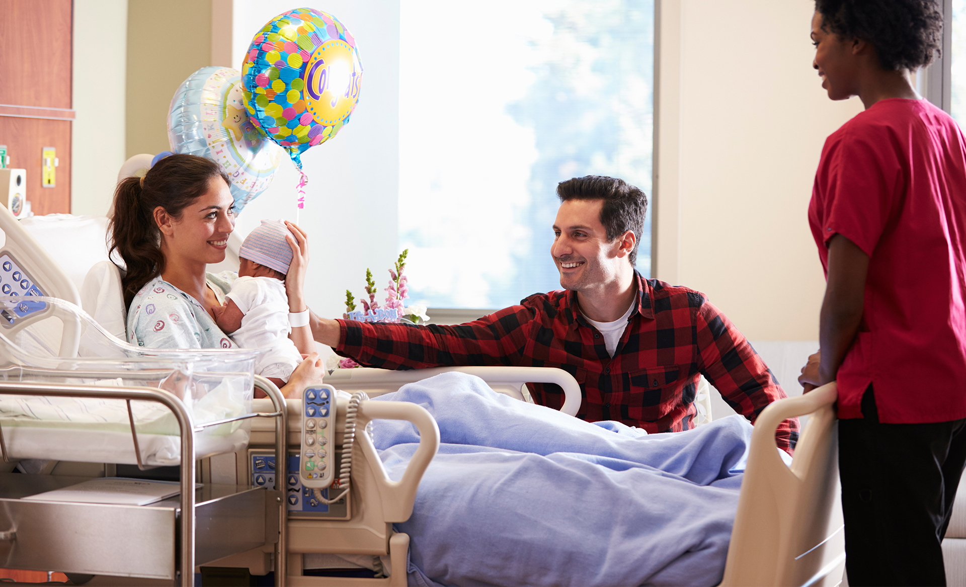 New parents with baby in hospital room